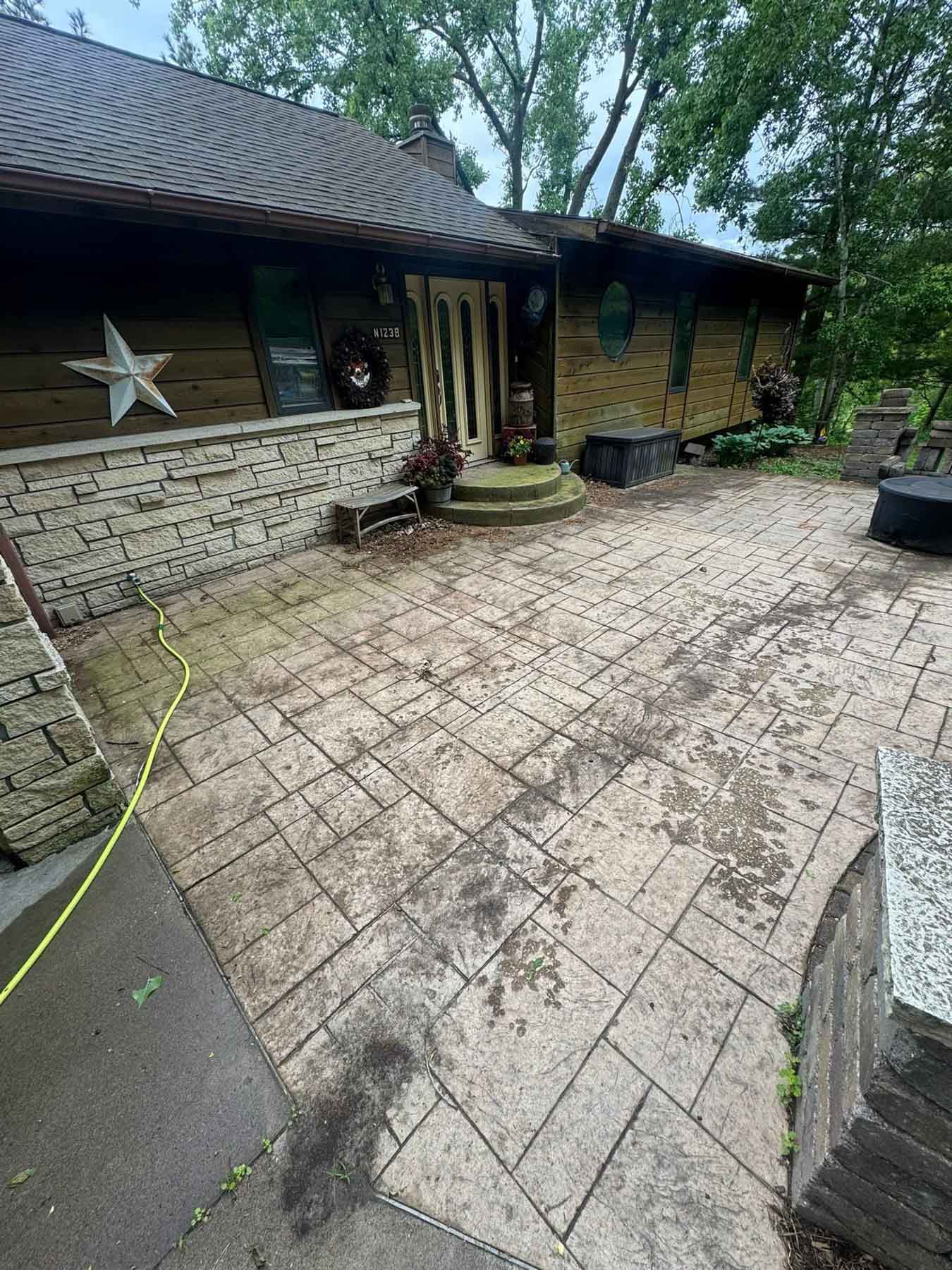 Paver Cleaning 38 Patio Before Being Cleaned By Driftless Exteriors